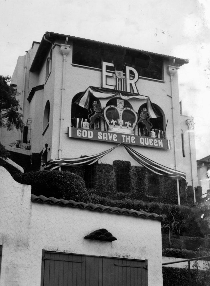 The Queen — StateLibQld 1 165035 House on Hamilton Hill, originally known as Cassa Anna, decorated for the visit of the Queen and Duke of Edinburgh to Brisbane in 1954